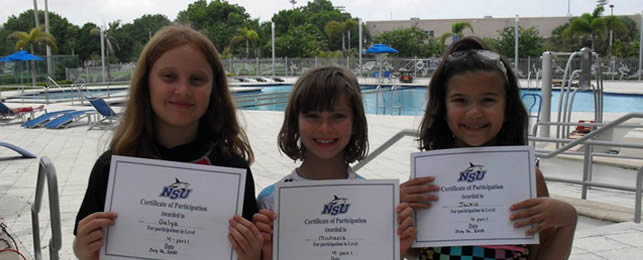 Children holding their swim certificates
